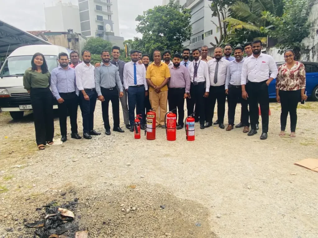 Fire Training Program 10 Peoples Insurance Group photo of employees with fire extinguishers after completing a workplace fire safety training program.