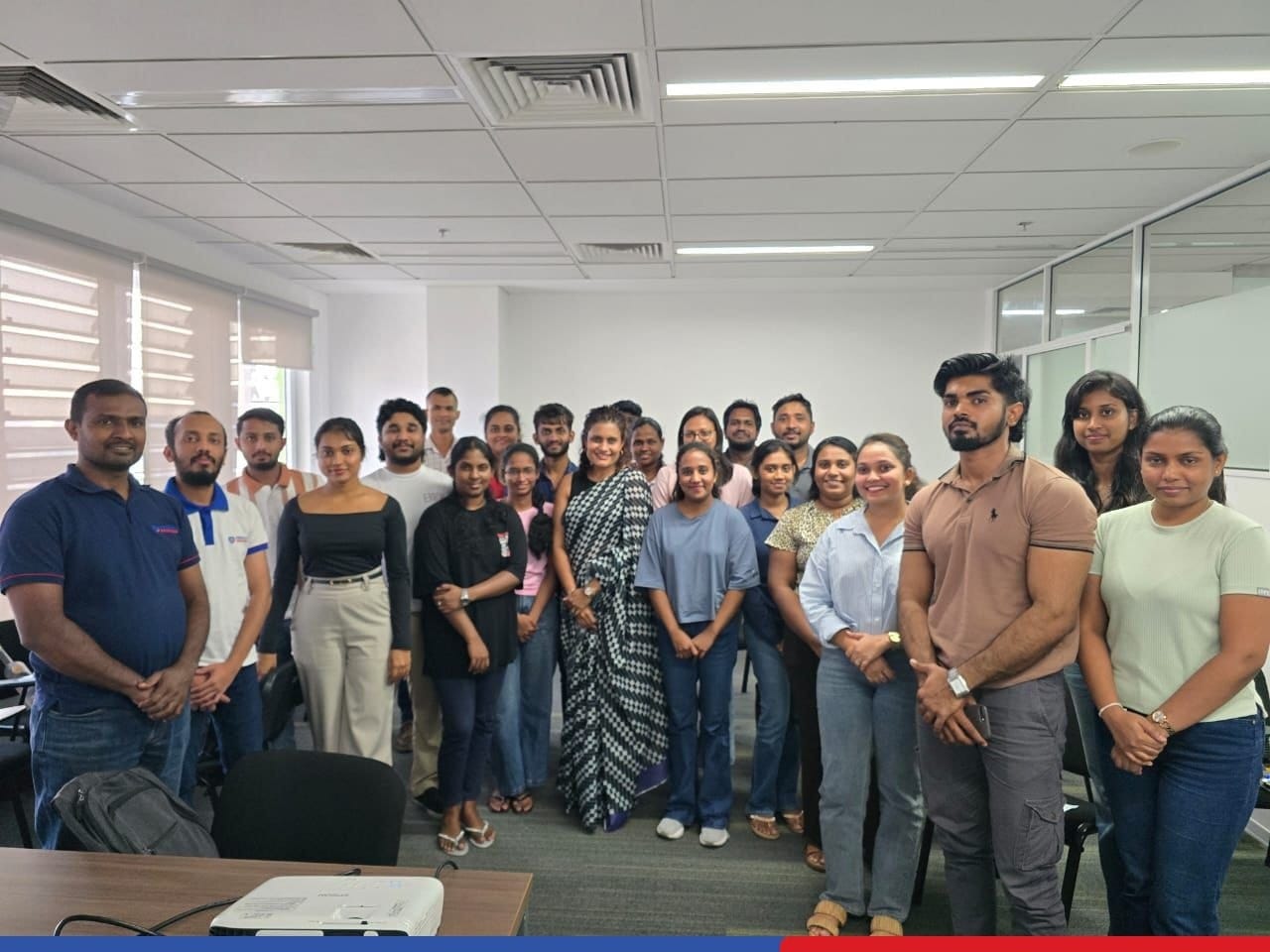 Building professional excellence through effective communication as participants gather for a group photo after a corporate training session